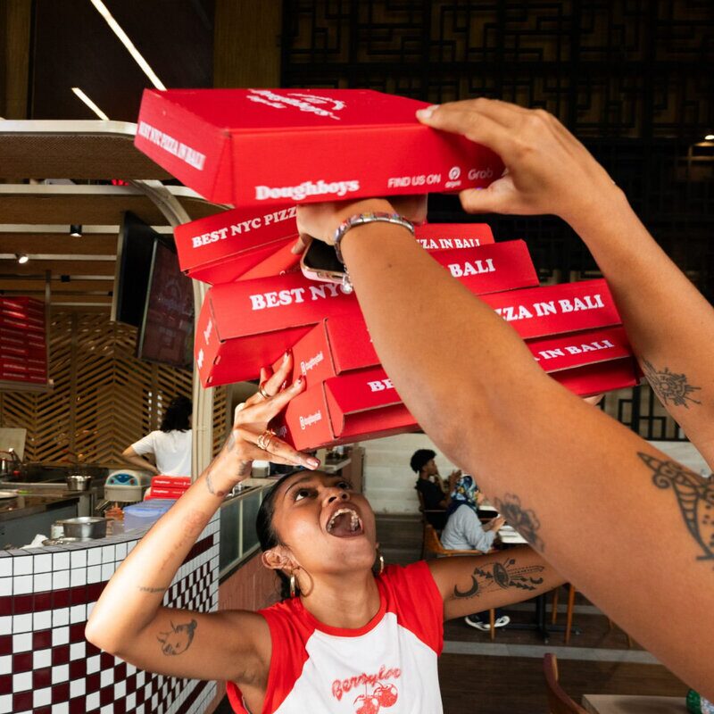 Stacking Doughboys pizza boxes at the restaurant
